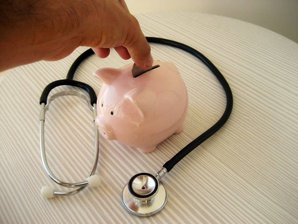 Stethoscope and piggy Bank Stethoscope and piggy Bank