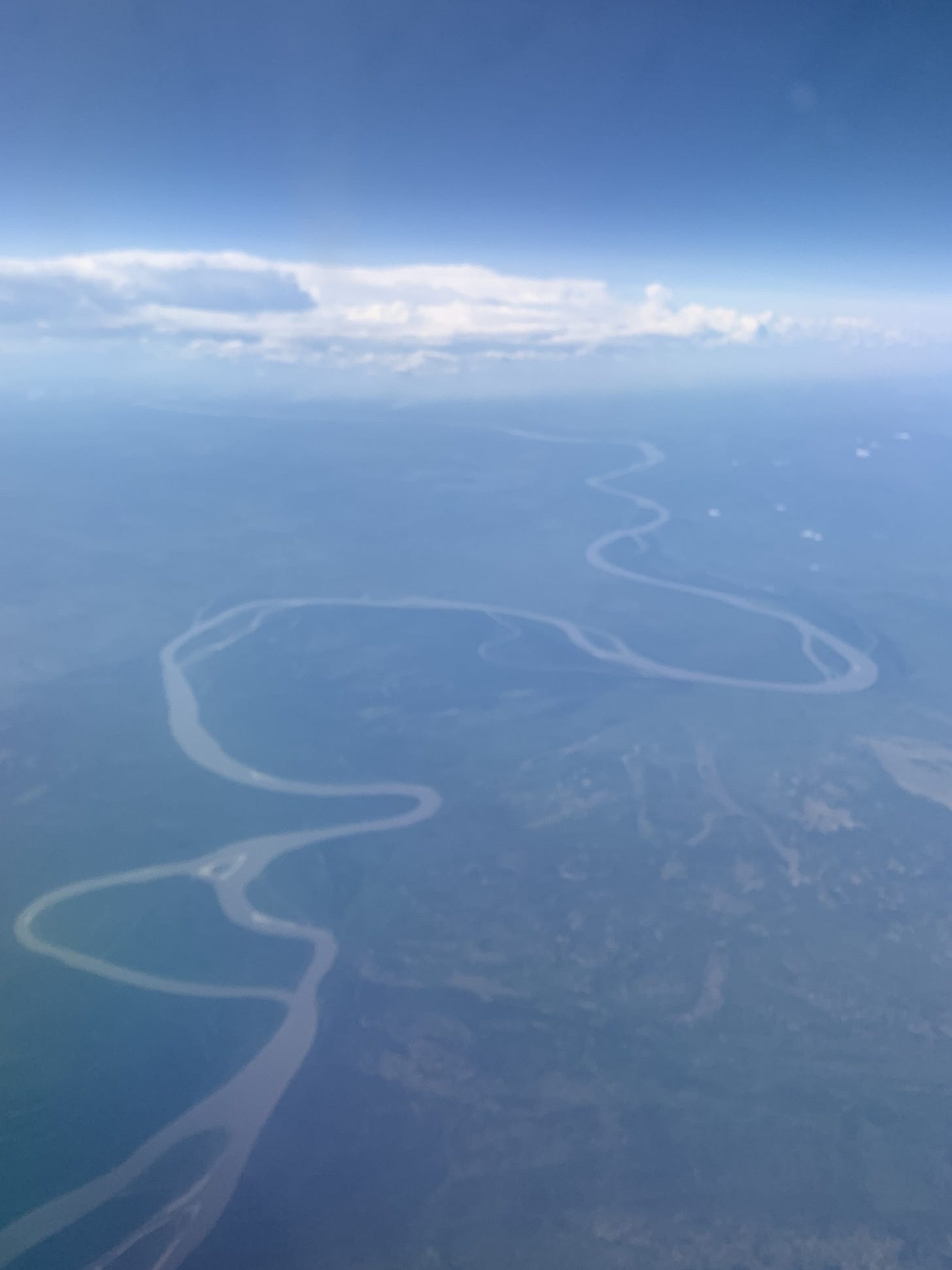 An aeriel view of the Athabasca River, Alberta, seen through wildfire haze.
