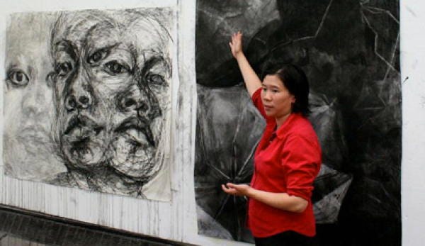 Clara Lieu with a drawing of hers