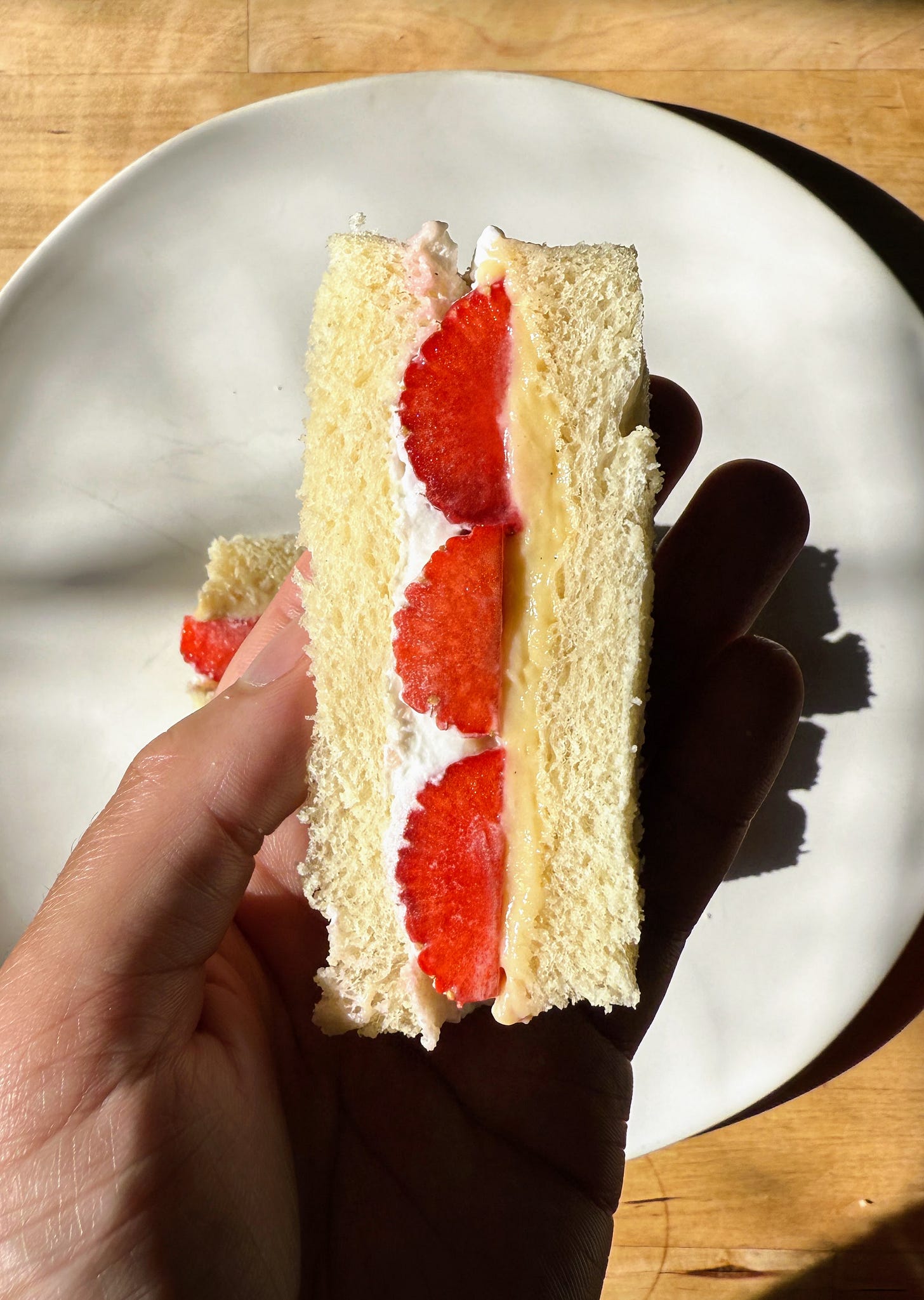 Hand holding strawberry sando