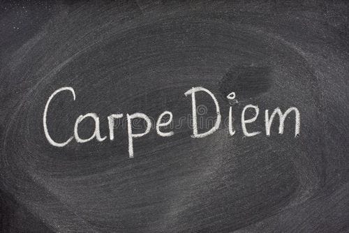 Enjoy life before it's too late, existential cautionary Latin phrase, Carpe DIem, a quote from Horace, handwritten with white chalk on blackboard. Carpe diem stock images, royalty-free photos and pictures