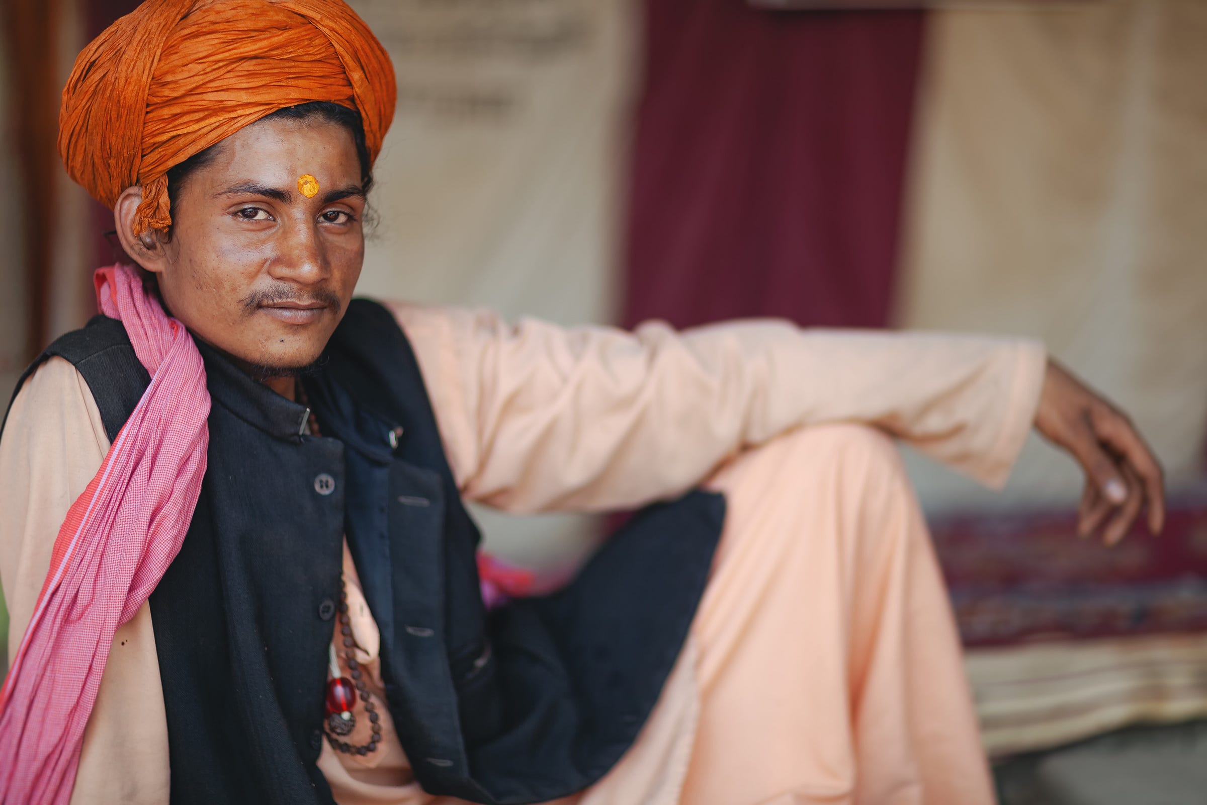 Ramesh, a sadhu devotee, relaxing at a Kumbh Mela festival in India. 1/1250, ƒ/1.2, ISO 100, 85mm Ramesh, a sadhu devotee, relaxing at a Kumbh Mela festival in India. 1/1250, ƒ/1.2, ISO 100, 85mm