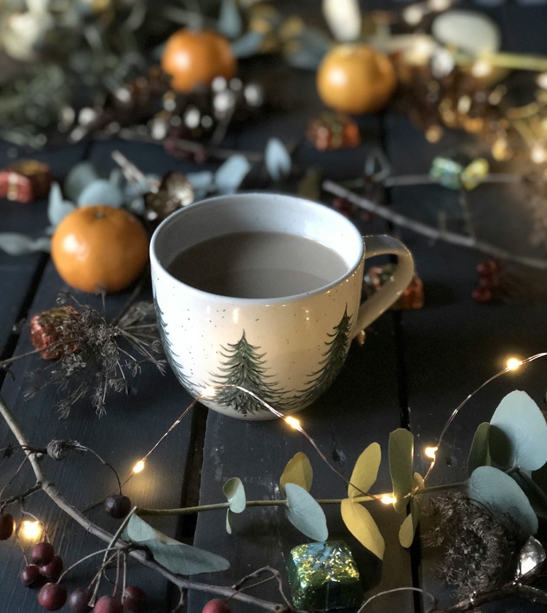 white teacup beside string lights white teacup beside string lights