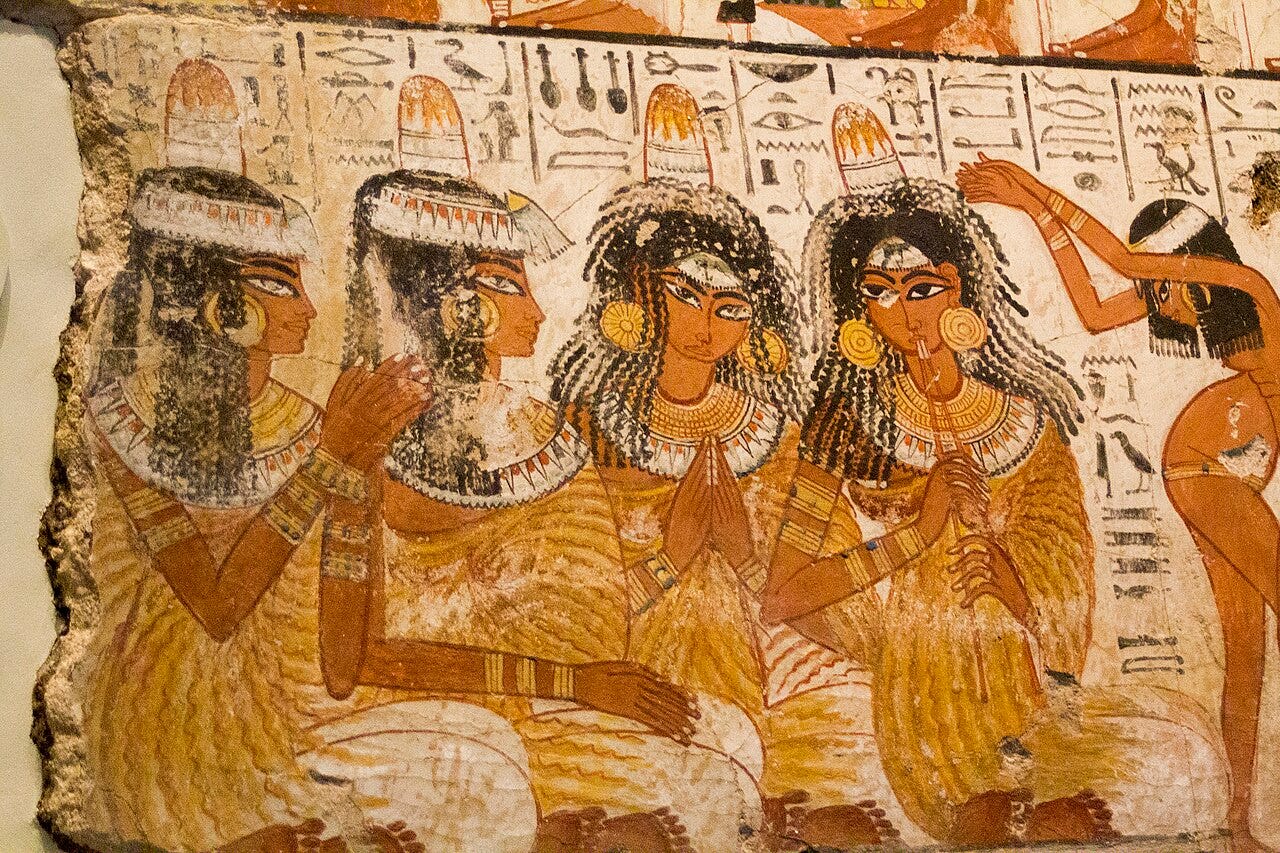 Ancient Egyptian tomb painting with orange ocher skin tones Ancient Egyptian tomb painting with orange ocher skin tones