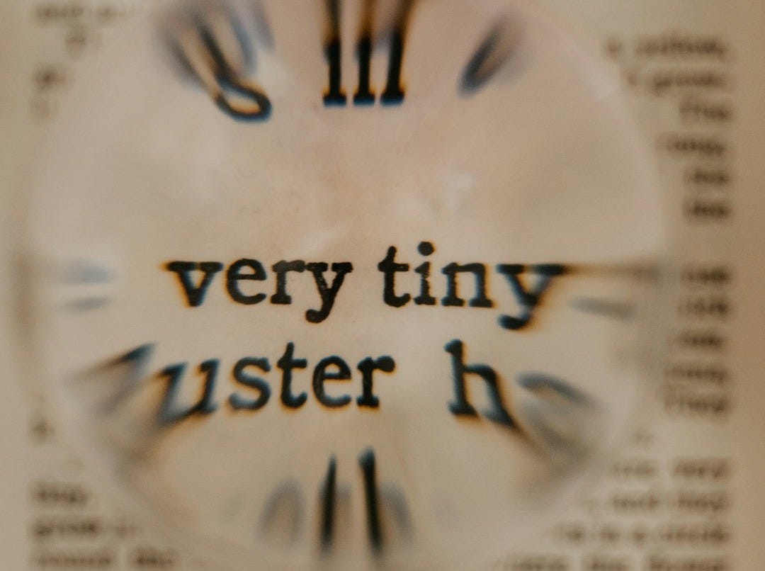 a close up of a clock on a piece of paper