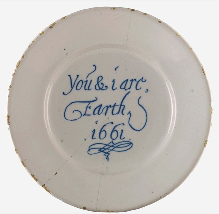 This may contain: a white and blue plate with writing on the side that says you & i are earth's 156 This may contain: a white and blue plate with writing on the side that says you & i are earth's 156