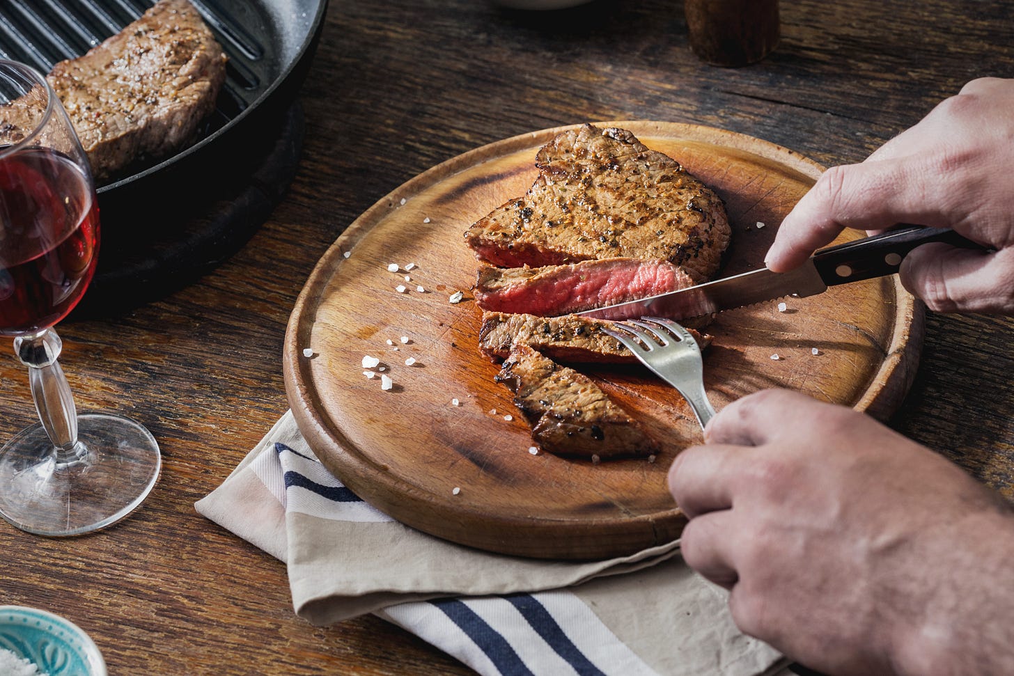 Person eating a steak with salt, no vegetables