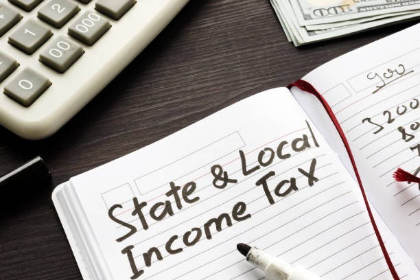 State and local income tax written in a note. State and local income tax written in a note. state and local tax deduction stock pictures, royalty-free photos & images