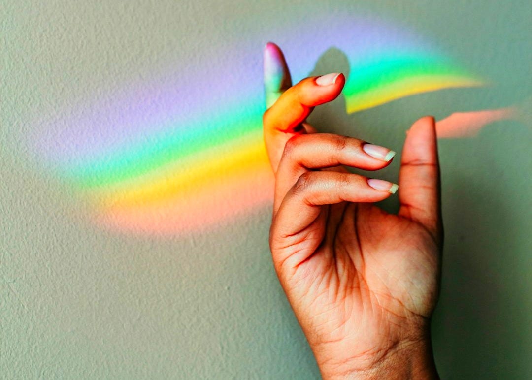 persons hand with purple light