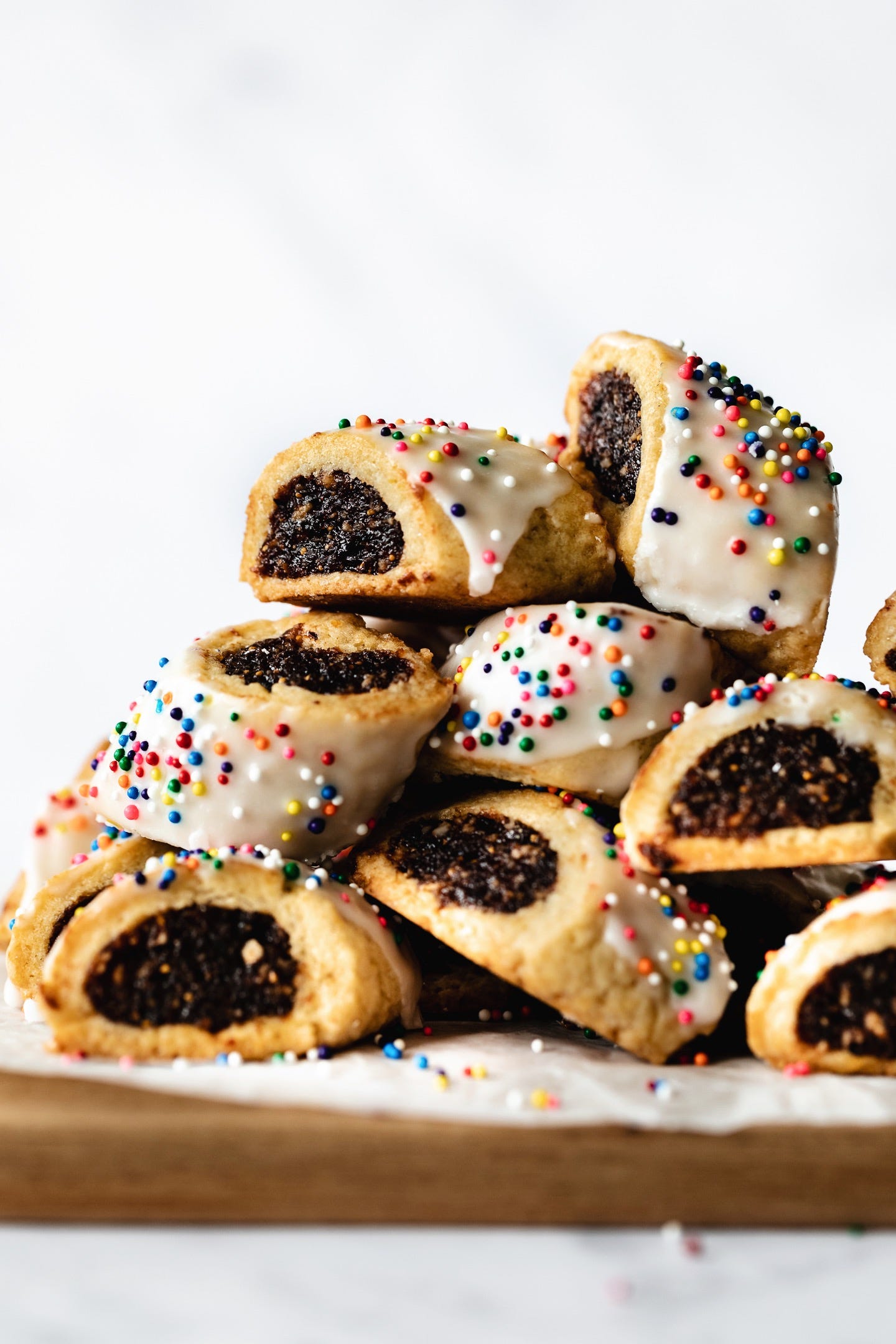 A stack of vegan Italian fig rolls on a white background