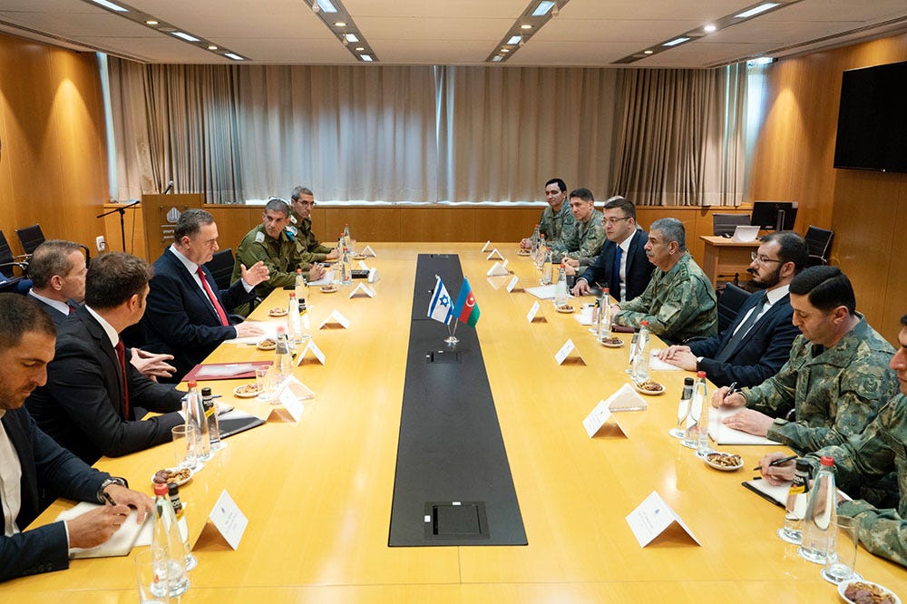 Meeting between the Defense Ministries of Israel and Azerbaijan in an office in Tel Aviv. The Israeli delegation sits on the left side of the table and is engaged with the Azerbaijani delegation to the right. The Israeli delegation is wearing suits while the Azerbaijani officials wear military uniforms. Meeting between the Defense Ministries of Israel and Azerbaijan in an office in Tel Aviv. The Israeli delegation sits on the left side of the table and is engaged with the Azerbaijani delegation to the right. The Israeli delegation is wearing suits while the Azerbaijani officials wear military uniforms.