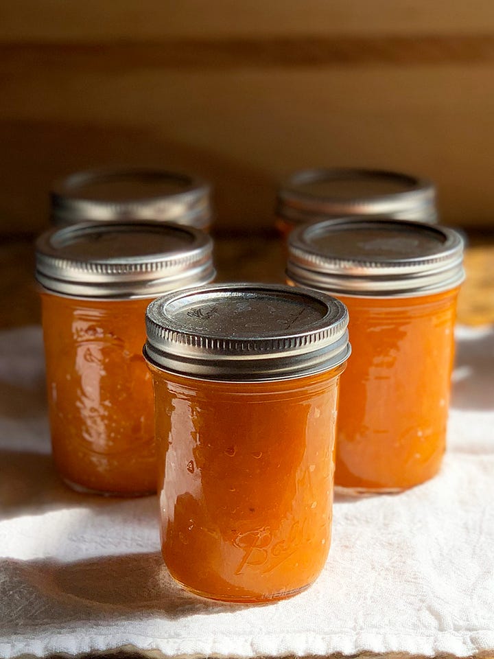 Close up of apricots in a box and a shot of apricot preserves cooling in jars.