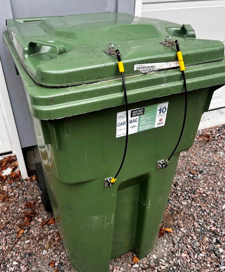 Garbage bin with clasps to lock the lid shut.
