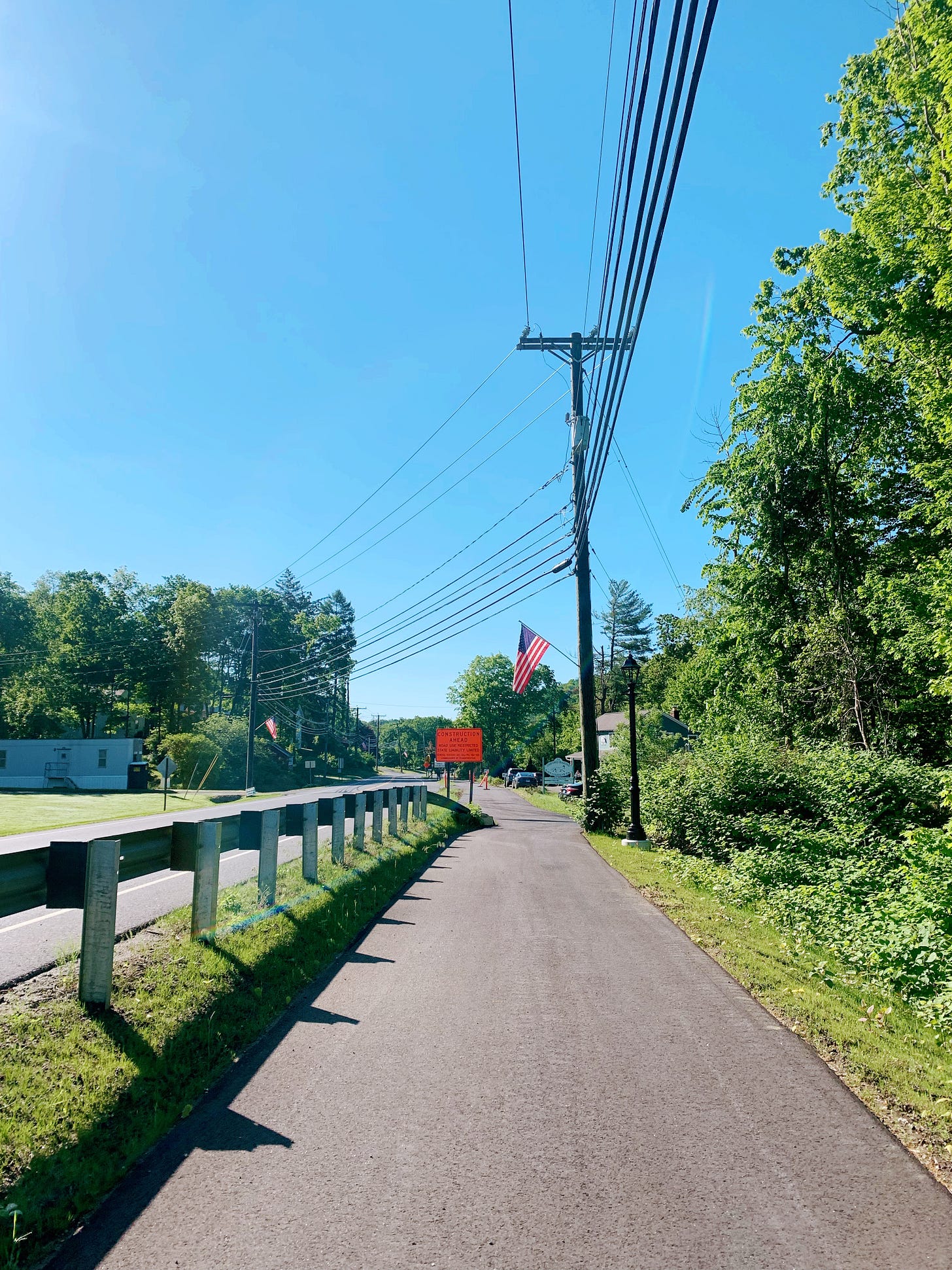 Sidewalk with a barrier separating it from the road