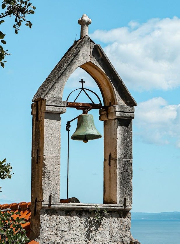 a bell tower with a bell on top of it