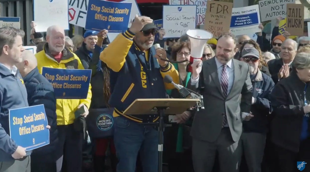 A crowd protests cuts to Social Security, carrying a variety of signs. Preprinted signs say 'Stop Socieal Security Office Closures.' Handmade signs include 'Social Security Is OUR Money,' 'FDR wanted me to have Social Security,' 'Impeach Trump,' 'Democracy Not Autocracy,' 'Hands off Social Security,' '46 years into Social Security: It's MY Money!' and 'JAIL MUSK' A crowd protests cuts to Social Security, carrying a variety of signs. Preprinted signs say 'Stop Socieal Security Office Closures.' Handmade signs include 'Social Security Is OUR Money,' 'FDR wanted me to have Social Security,' 'Impeach Trump,' 'Democracy Not Autocracy,' 'Hands off Social Security,' '46 years into Social Security: It's MY Money!' and 'JAIL MUSK'