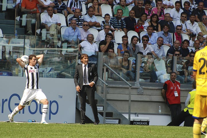 Juventus vs Parma, September 11, 2011: team huddle, player introductions, Antonio Conte coaching from the sideline, Pirlo and Del Piero in action, and Juventus players celebrating a goal during the opening match at Juventus Stadium.
