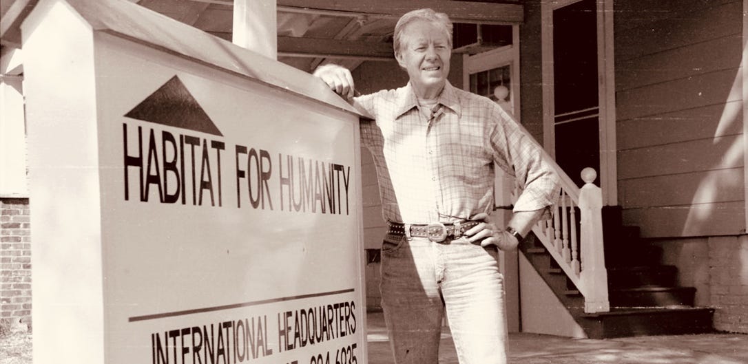 A person leaning on a sign

Description automatically generated