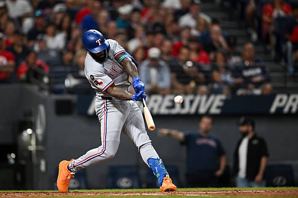 Adolis García of the Texas Rangers hits a solo home run during the fourth inning against the Cleveland Guardians at Progressive Field on September...