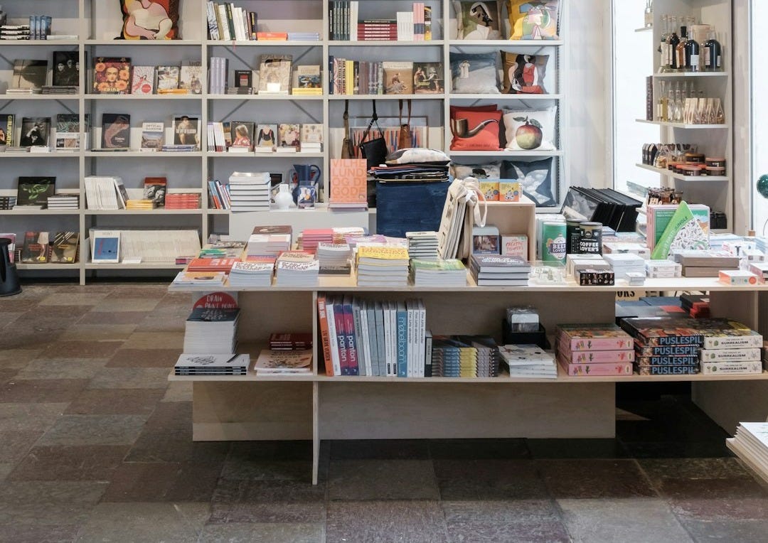 books on white wooden shelf books on white wooden shelf