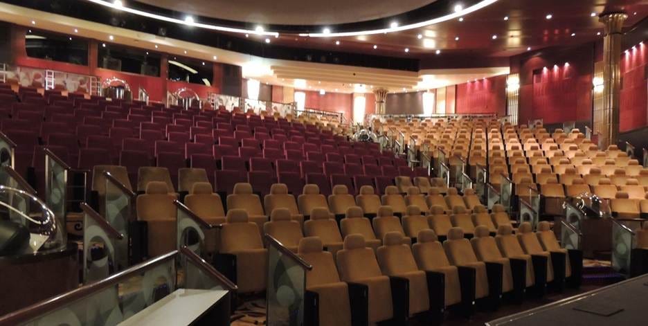 A large auditorium with rows of chairs

AI-generated content may be incorrect.