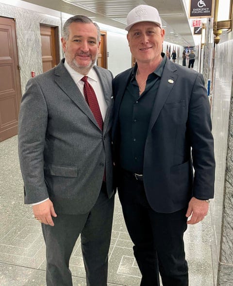two men in suits in a corridor