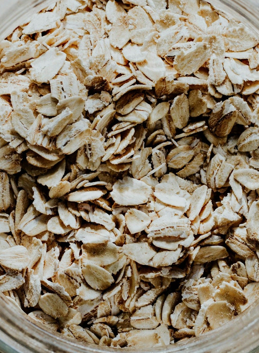 a glass bowl filled with oats on top of a table a glass bowl filled with oats on top of a table