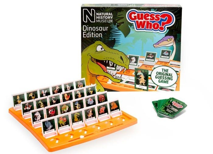 Guess Who? Dinosaur Edition Board Game packaging styled with one of the boards and a stack of Guess Who? cards.