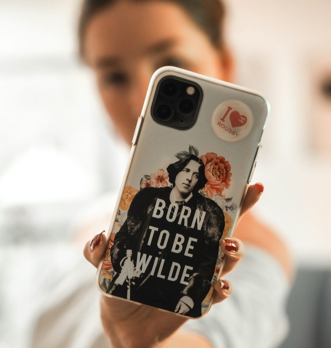 person holding white and black iphone case person holding white and black iphone case