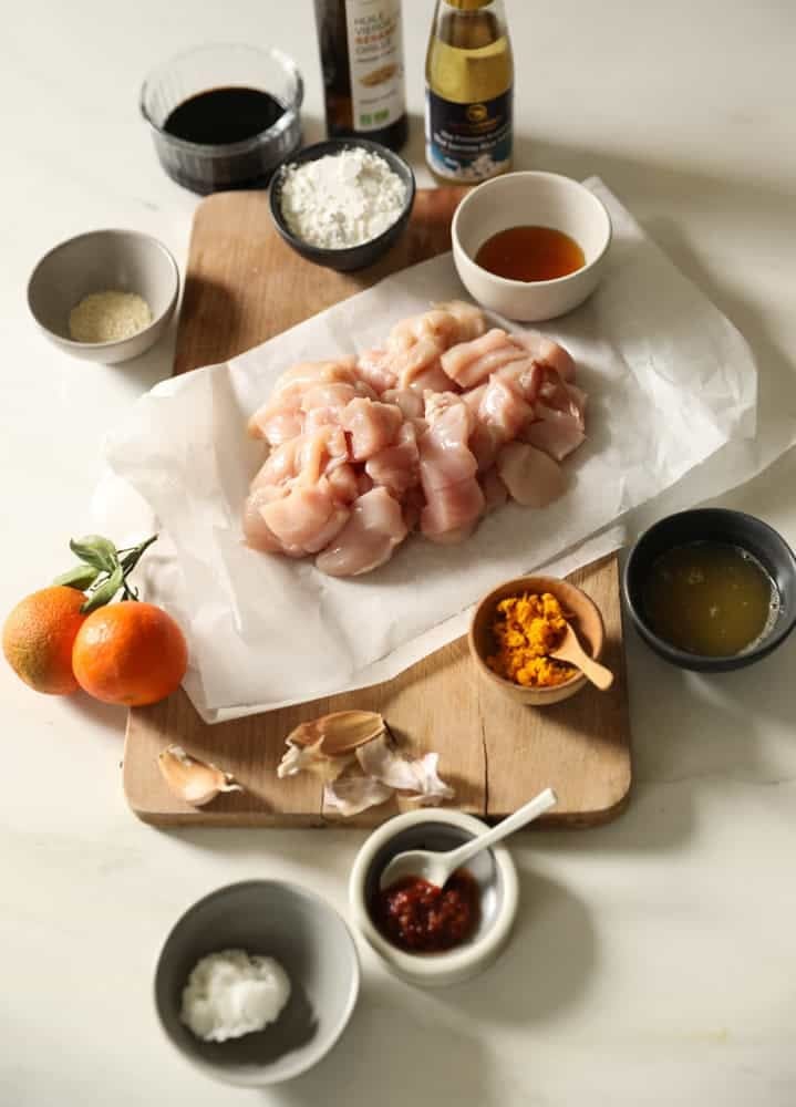 Chicken, Soy Saucem Rice Wine Vinegar, orange zest and juice, laid out on a counter.