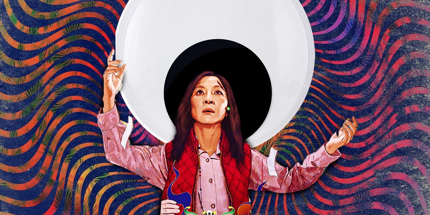 Evelyn standing with arms open and a massive googly eye behind her like a moon (from Collider).