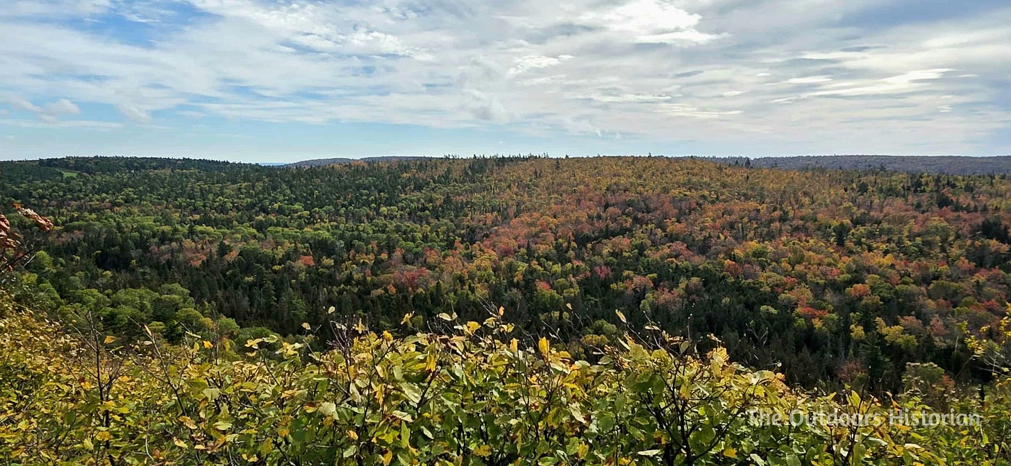 A mix of golden and yellow hardwoods mix with green conifers over the raised ridges of the Keweenaw Peninsula.