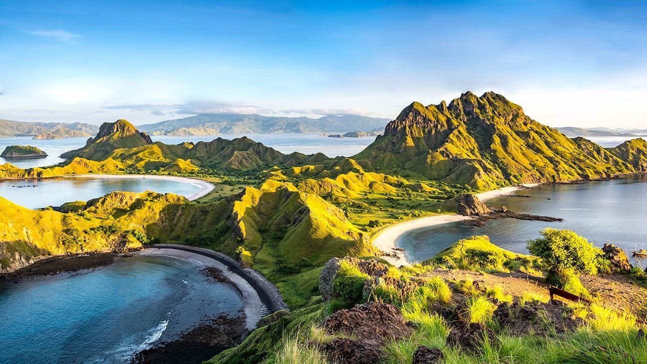 Panoramic aerial view of Komodo Island, Indonesia, showcasing its rugged hills, turquoise waters and remote coastline. Panoramic aerial view of Komodo Island, Indonesia, showcasing its rugged hills, turquoise waters and remote coastline.