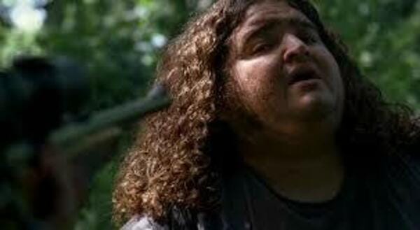 Close up shot of Hugo “Hurley” Reyes (Jorge Garcia). There is a gun pointed at his head, visible in the extreme foreground of the left of the frame.