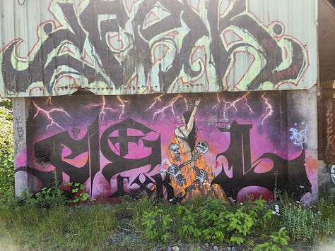 Graffiti covers skate ramps, old buildings and an underpass.