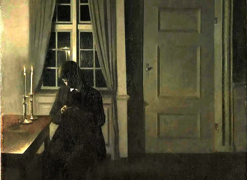 A man sits alone in a dark room counting coins