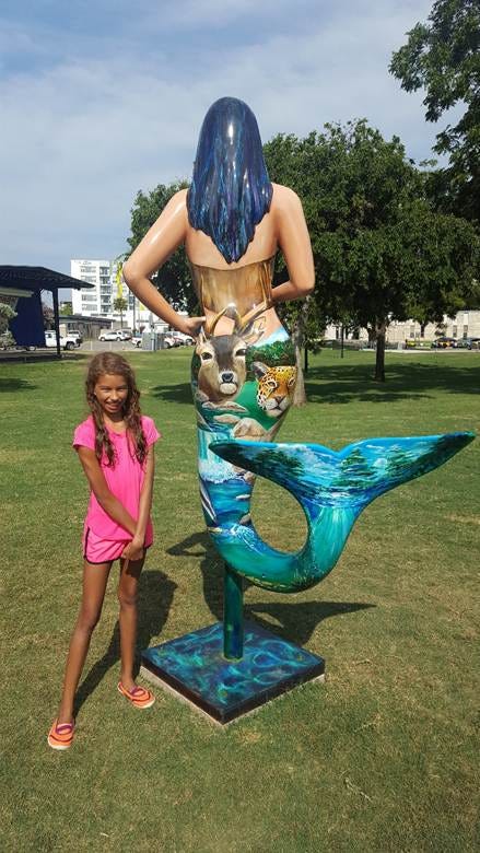 A child standing next to a statue of a mermaid
AI-generated content may be incorrect. A child standing next to a statue of a mermaid
AI-generated content may be incorrect.