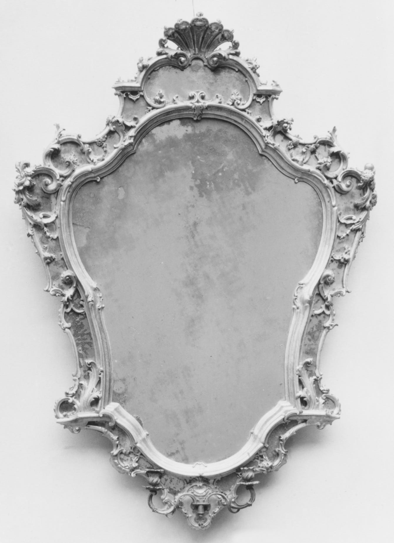 A gray mirror with a cloudy surface that is non-reflective.