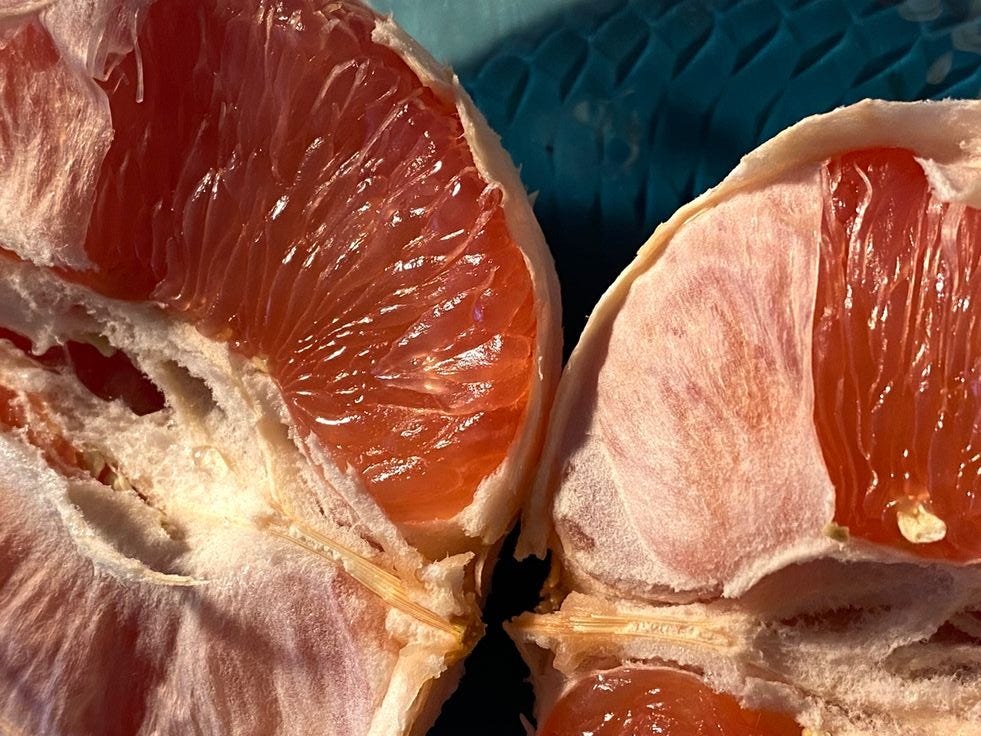 This may contain: two halves of grapefruit on a blue plate