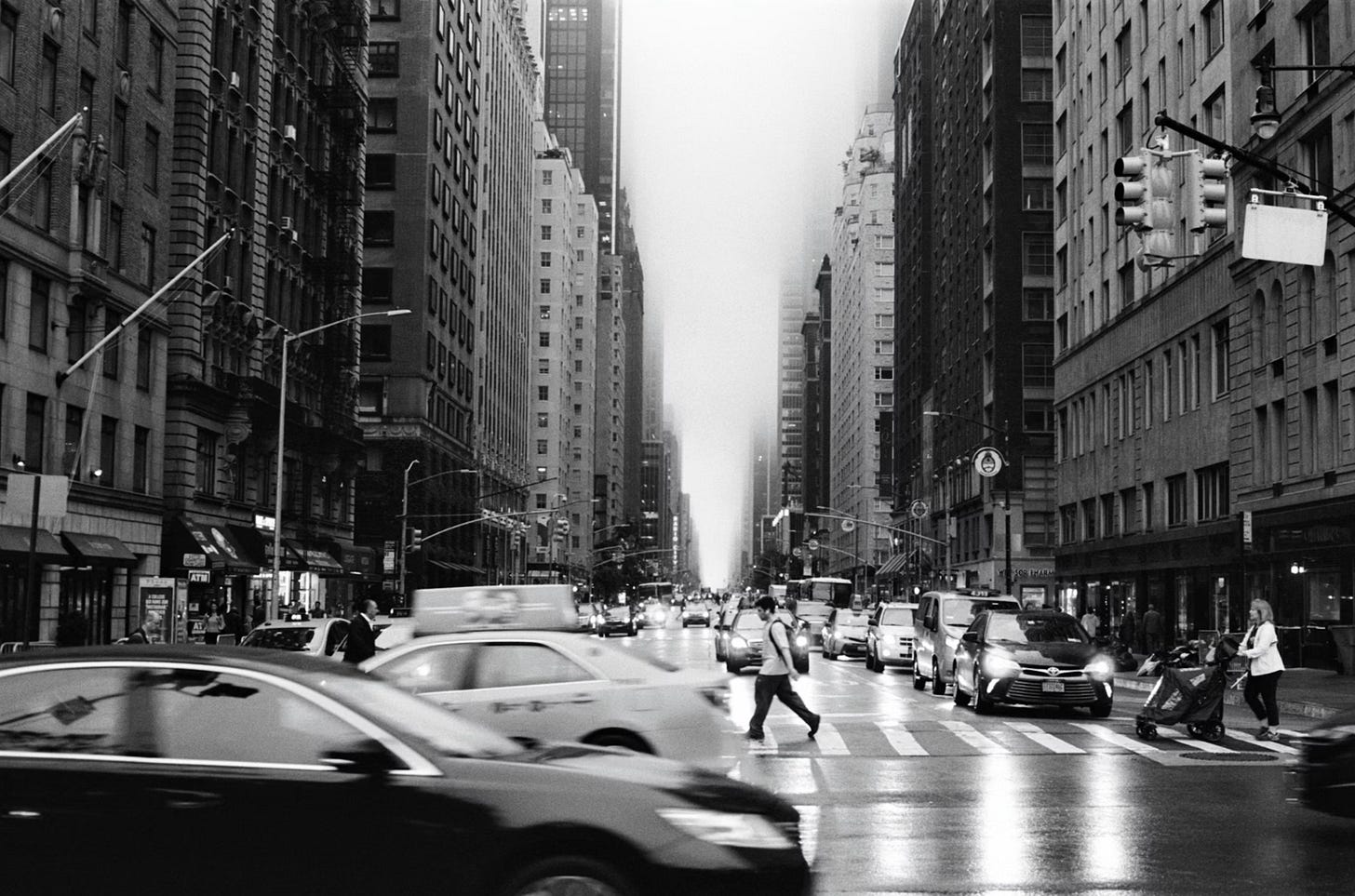 A busy city street with cars and people crossing

AI-generated content may be incorrect.