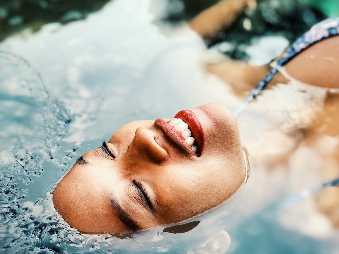 floating woman on body of water floating woman on body of water