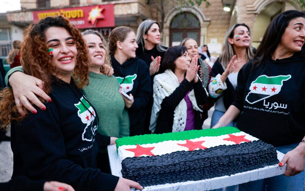 Residents in the Israeli Druze village of Majdal Shams in the Golan Heights celebrate on December 9, 2024, after Islamist-led rebels declared that they had taken the Syrian capital in a lightning offensive, sending President Bashar al-Assad fleeing and ending five decades of Baath rule in Syria. (Menahem Kahana / AFP) Residents in the Israeli Druze village of Majdal Shams in the Golan Heights celebrate on December 9, 2024, after Islamist-led rebels declared that they had taken the Syrian capital in a lightning offensive, sending President Bashar al-Assad fleeing and ending five decades of Baath rule in Syria. (Menahem Kahana / AFP)