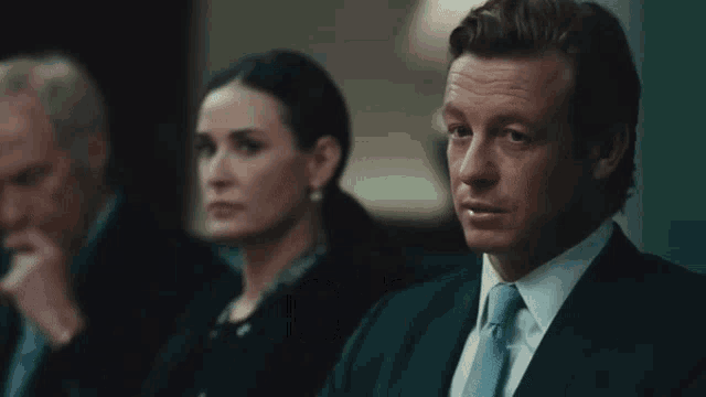 a man in a suit and tie says sell it all in front of a woman a man in a suit and tie says sell it all in front of a woman