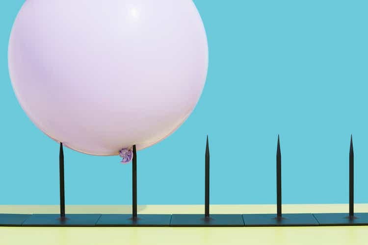Balloon impaled on metal spikes