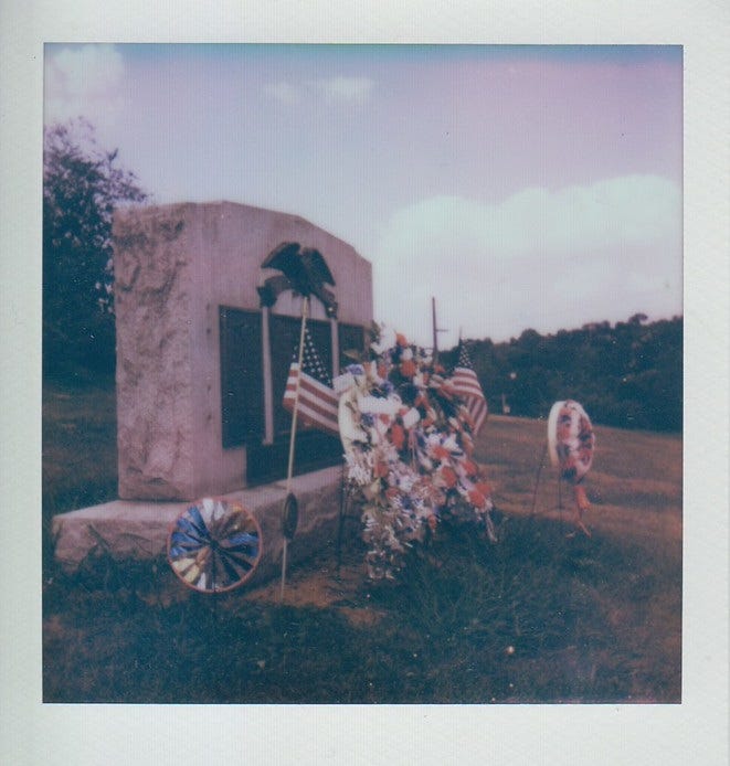 Polaroid of the war memorial in front of the Mifflin school in Lincoln Place.