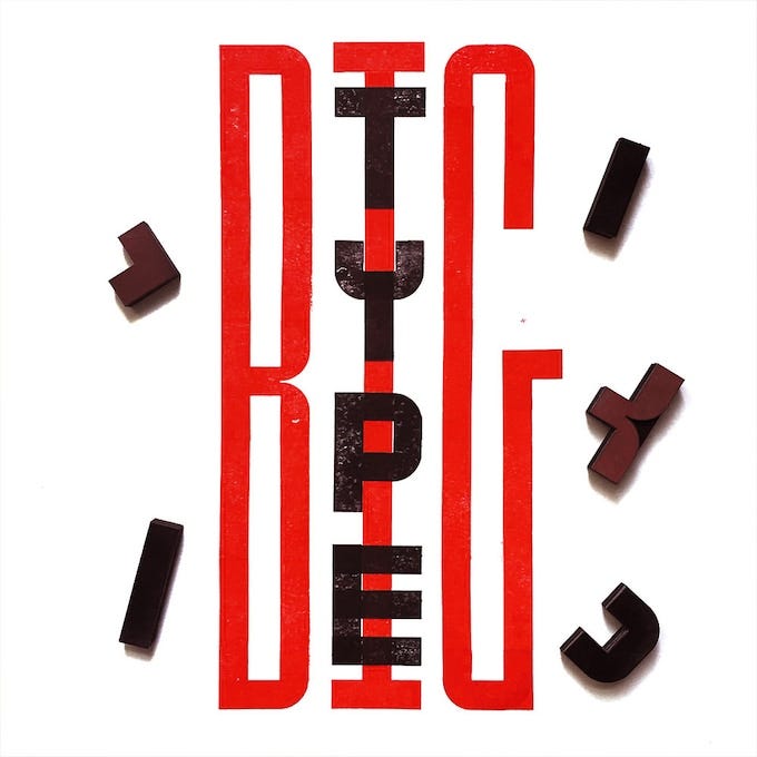 the words "BIG TYPE" stamped in elongated letters in red and black