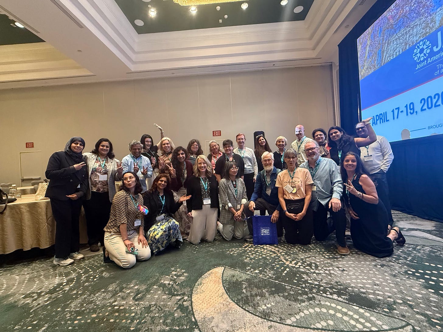 Large international group of JAHC attendees posing together at the closing celebration of World Homeopathy Awareness Week. 