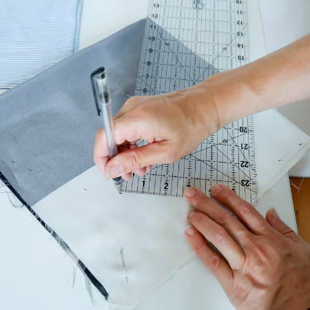 using a black erasable fabric marker and ruler to draw a cutting line for a circle on fabric using a black erasable fabric marker and ruler to draw a cutting line for a circle on fabric