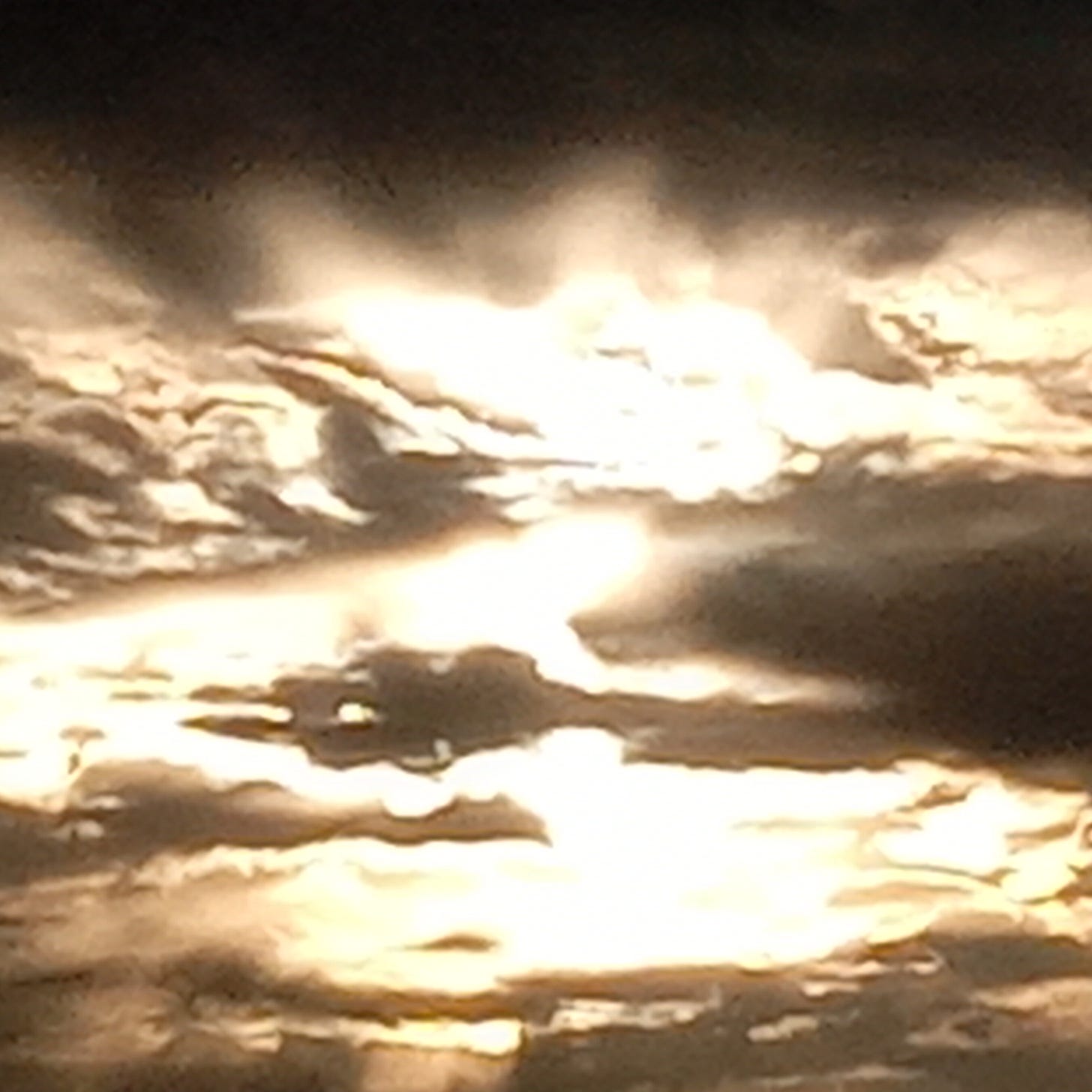 Sun rays piercing through gray clouds, symbolizing the decision to push forward with discipline on gloomy days