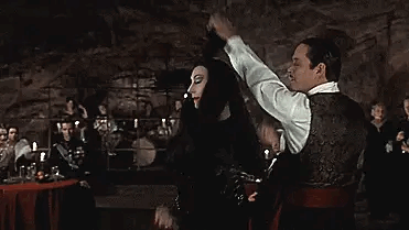 Gomez and Morticia Addams dancing a tango
